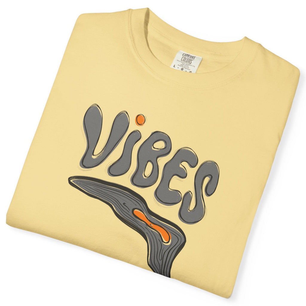 Folded yellow t-shirt with 'VIBES' graphic design on a white background