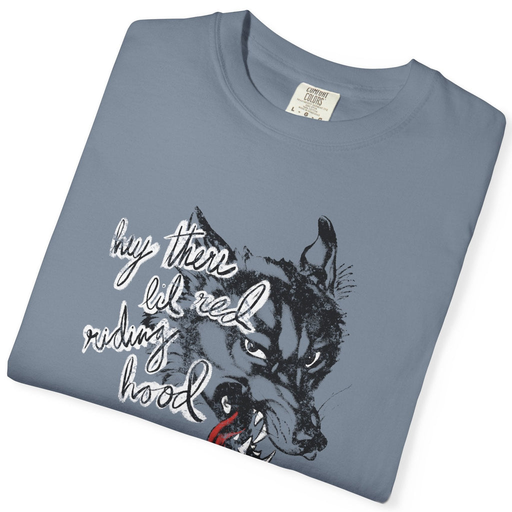 Folded blue t-shirt with graphic design of a wolf and the phrase "hey there little red riding hood."