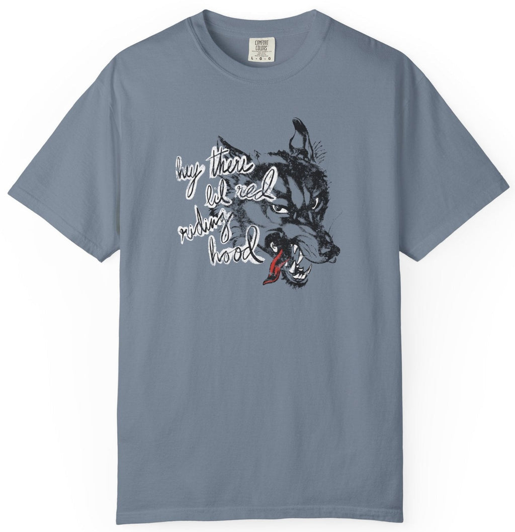 blue gray t-shirt on a white background  with graphic design of a wolf and the phrase "hey there little red riding hood."