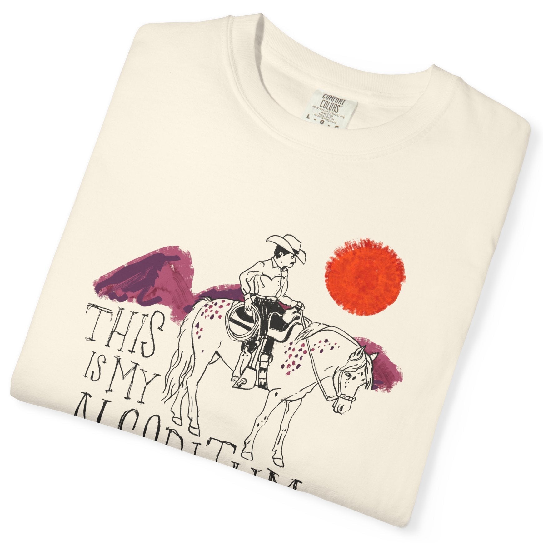 Folded t-shirt with a graphic of a person on a horse and text 'This is my bloodline' on a white background