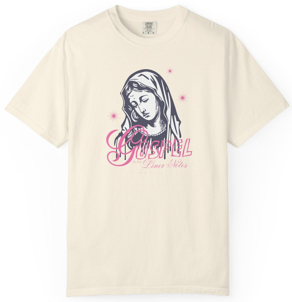 Beige t-shirt with a graphic design of a face and text on a white background