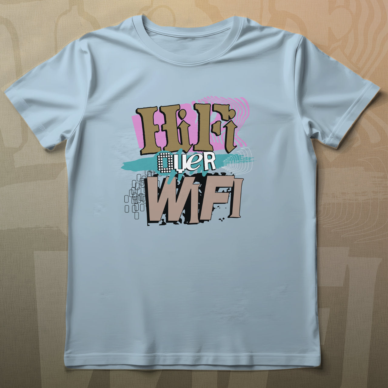 Light blue t-shirt with colorful text design on a wooden surface