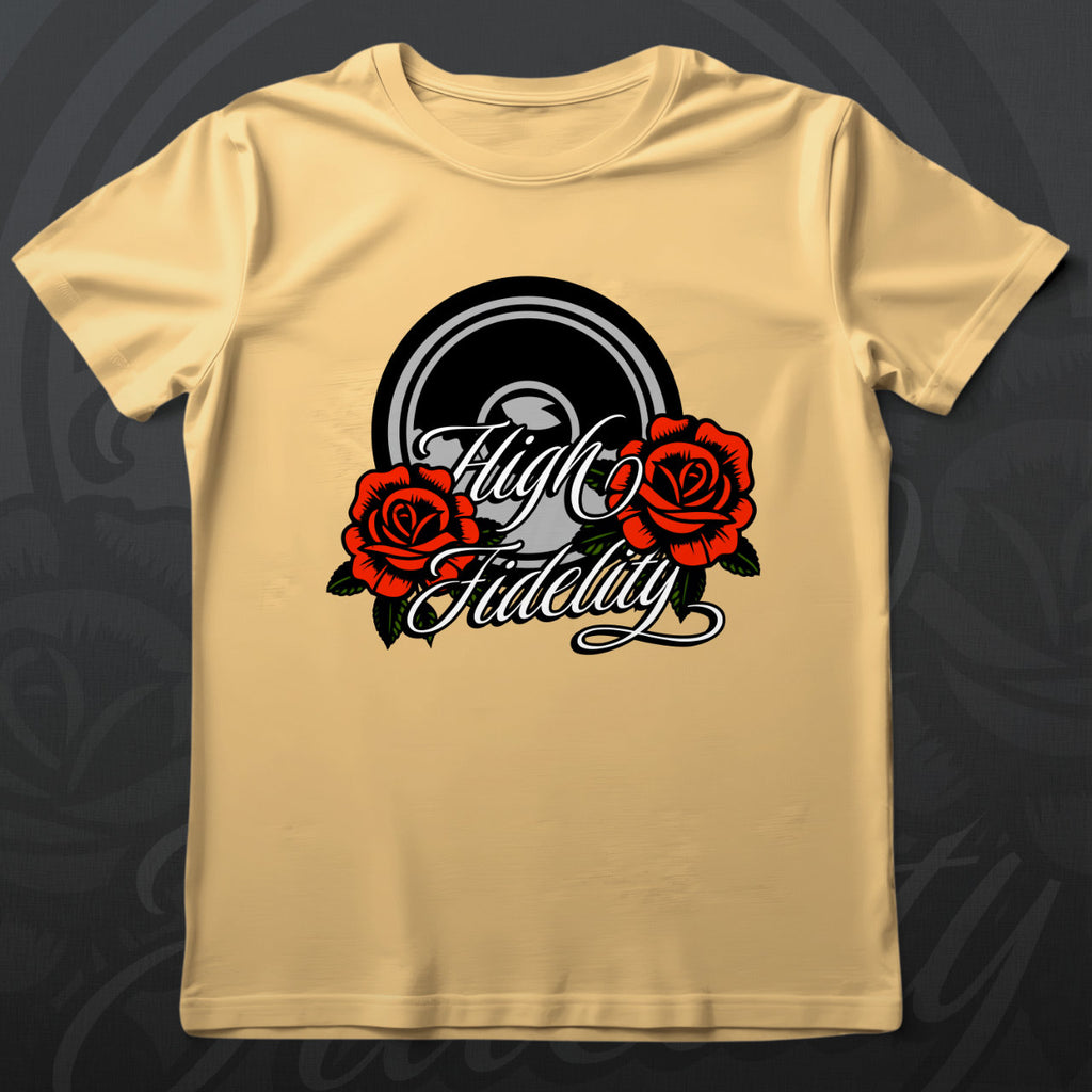 Yellow t-shirt with 'High Fidelity' design featuring roses on a wooden surface