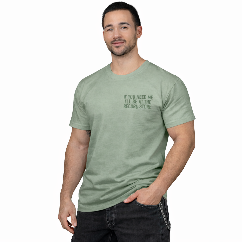 Man wearing a green t-shirt with text on a white background