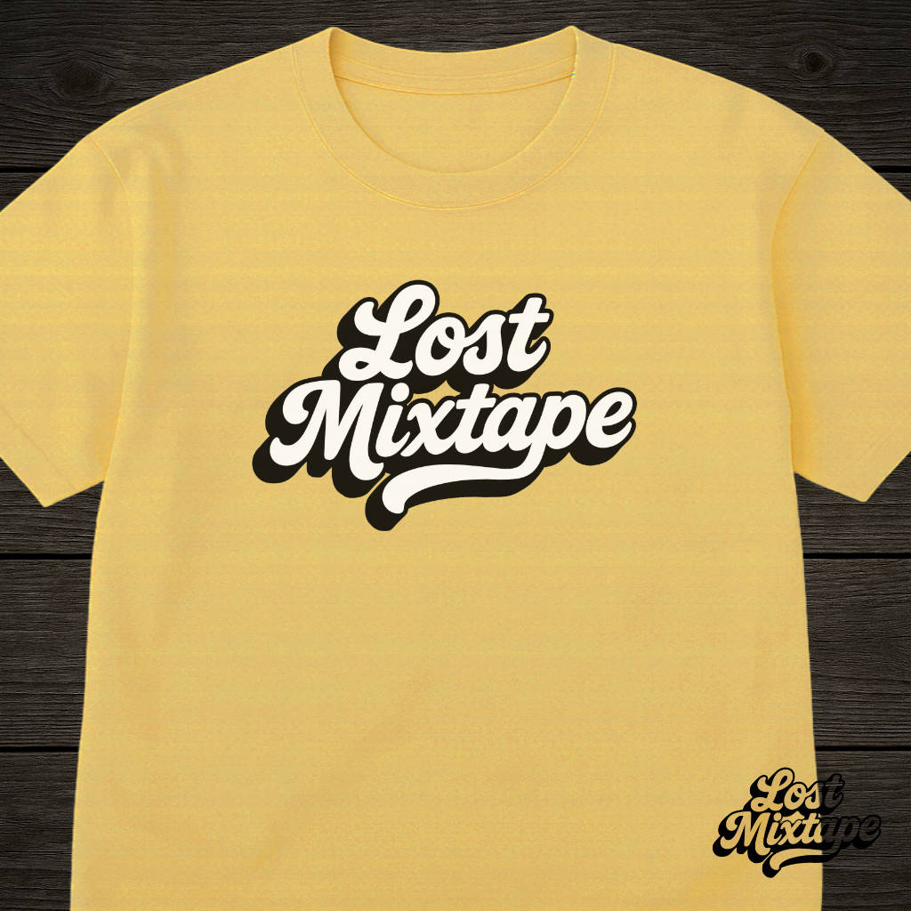 Yellow t-shirt with 'Lost Mixtape' text on a wooden surface