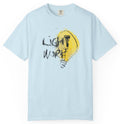 Light blue t-shirt with a yellow light bulb graphic and black text on a white background