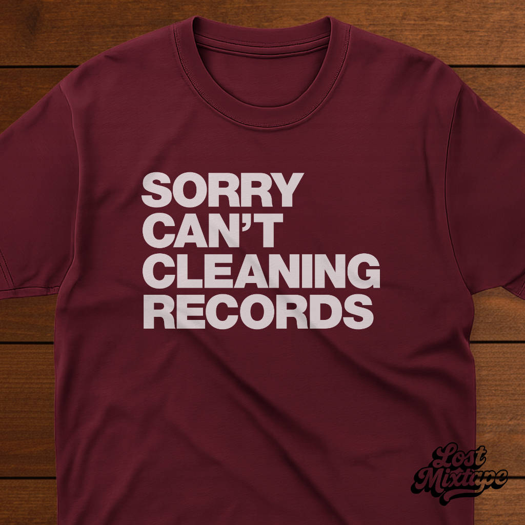 Maroon t-shirt with white text 'SORRY CAN'T CLEANING RECORDS' on a wooden background