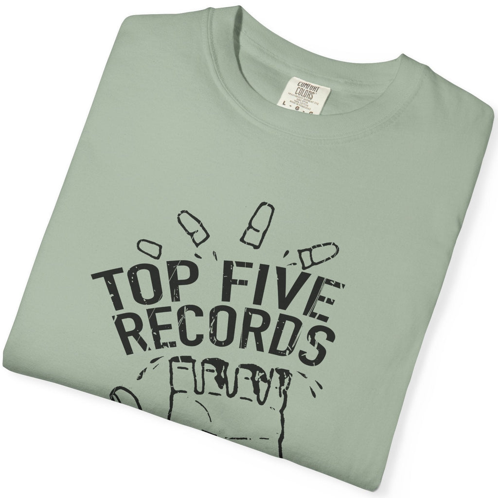 Folded green t-shirt with 'Top Five Records' text on a white background