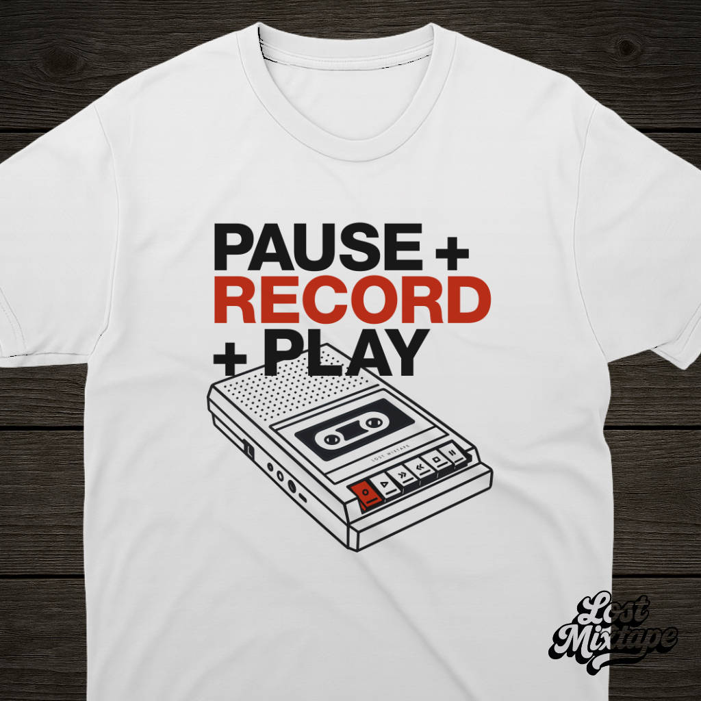 White t-shirt with a cassette tape graphic and text on a wooden surface